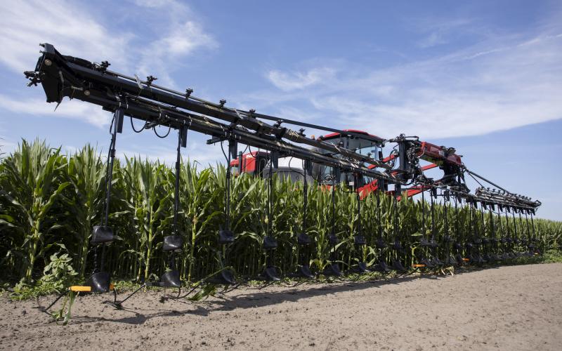 An elevated tractor applies fertilizer to a corn field in May. UF/IFAS is looking to conduct new research on the best management practices for key crops, including how much fertilizer to use. (COURTESY UF/IFAS)