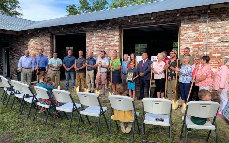 Friends, family and coworkers of J. Don Allen gather for the ceremonial groundbreaking of the J. Don Allen Cultural Center at Heritage Park and Gardens on Friday. (COURTESY)