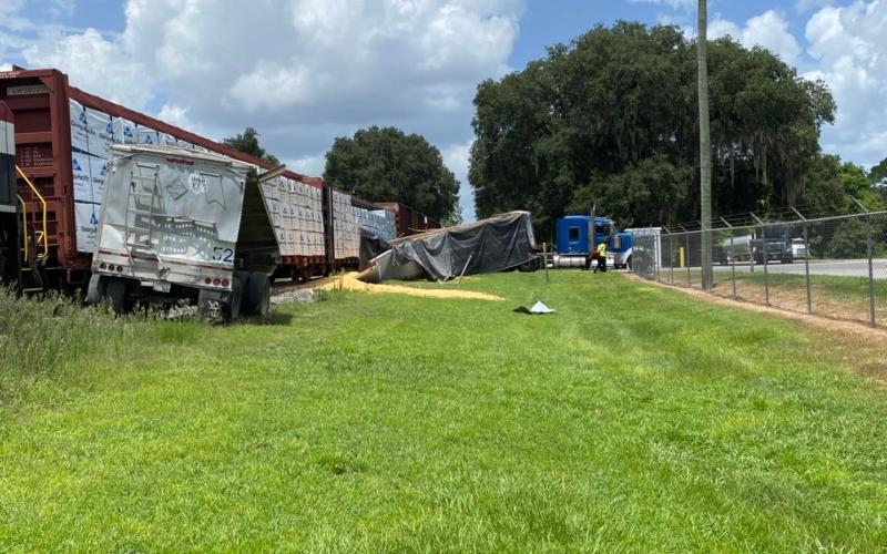 A train hit a trailer full of corn near the Pilgrim’s Pride Feed Mill in Live Oak on Friday, spilling the load onto the ground and railroad tracks. (COURTESY SUWANNEE COUNTY FIRE RESCUE)