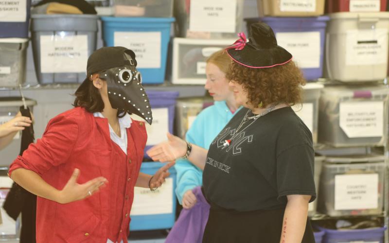 Students attending the Columbia High School Theater Camp try on various costumes Wednesday morning. Approximately 50 students have been attending the week-long camp, which culminates with a production on Friday afternoon. (TONY BRITT/Lake City Reporter)
