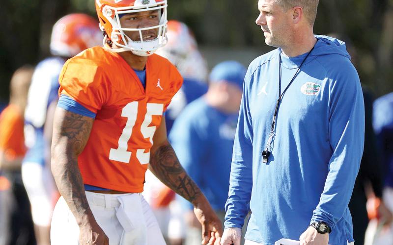 Florida quarterback Anthony Richardson, talking with Gators coach Billy Napier during a spring practice, has caught UF legend Steve Spurrier’s attention. (STEPHEN M. DOWELL/Orlando Sentinel/TNS)