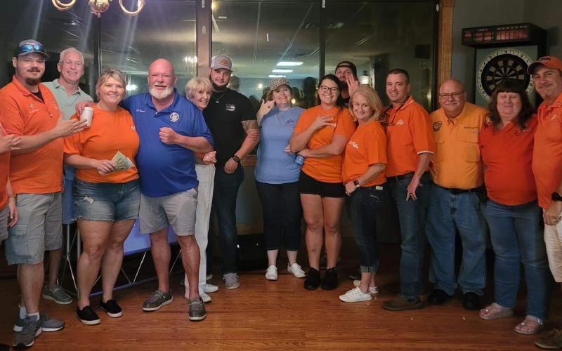 Members of the Elks Lodge pose with CCSO Deputy Shane Hartopp (black shirt) during the Lodge’s barbecue dinner fundraiser. Local residents also donated cakes to be auctioned off, with the proceeds benefiting Hartopp’s recovery from a flash bang grenade injury. (COURTESY)