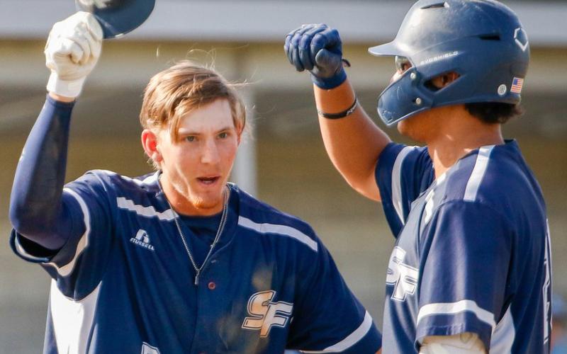 Santa Fe’s Tyler Shelnut (left) celebrates after scoring a run during a game this past season. (COURTESY OF SANTA FE ATHLETICS)