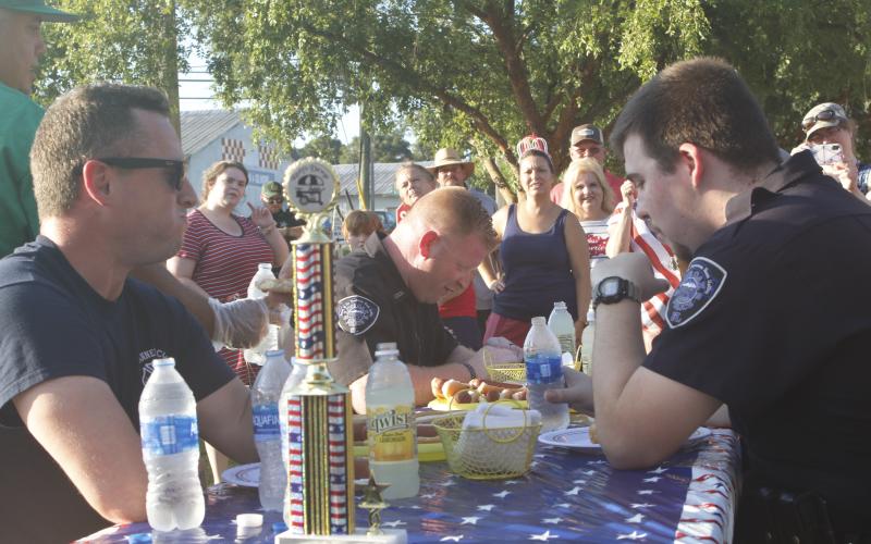 Suwannee County Fire Rescue Captain Chip Leathlean (left) takes a moment during Monday’s inaugural Rudy’s Dawgs Hot Dog Eating Contest. (JAMIE WACHTER/Lake City Reporter)