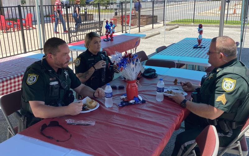 Members of the Columbia County Sheriff’s Office talk while enjoying a free lunch Friday at the First Responder Appreciation Luncheon at GulfCoast Financial Services. (TODD WILSON/Lake City Reporter)