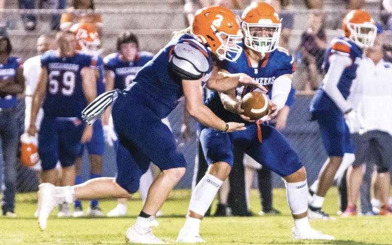 Branford quarterback Cohen David hands the ball off to running back Caden Coker during last Friday’s Preseason Classic against Fort White. (CHRISTINA FEAGIN/Special to the Reporter)