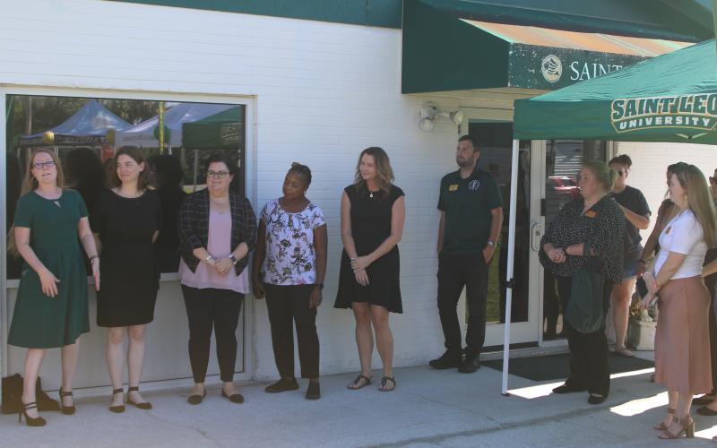 Lisa Burnham (far left) address the crowd during the Saint Leo University Lake City Education Center 25th Anniversary Celebration on Thursday afternoon. (TONY BRITT/Lake City Reporter)