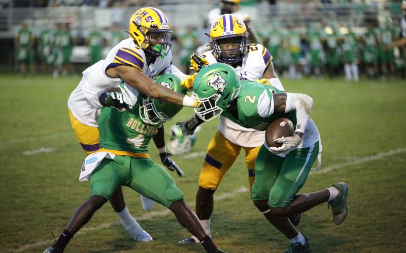 Columbia safety Amare Ferrell (top left) and cornerback Kani Fulton (top right) go in to tackle Suwannee kick returner Jay Smith during last Friday’s Preseason Classic. (BRENT KUYKENDALL/Lake City Reporter)