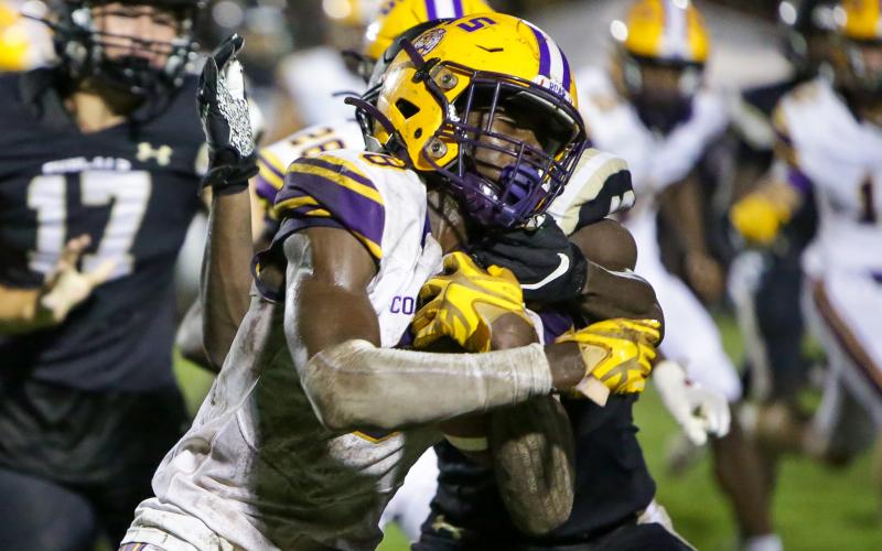 Columbia receiver Jaylen Cooper gets tackled on a kickoff return by a Buchholz defender on Thursday night. (BRENT KUYKENDALL/Lake City Reporter)