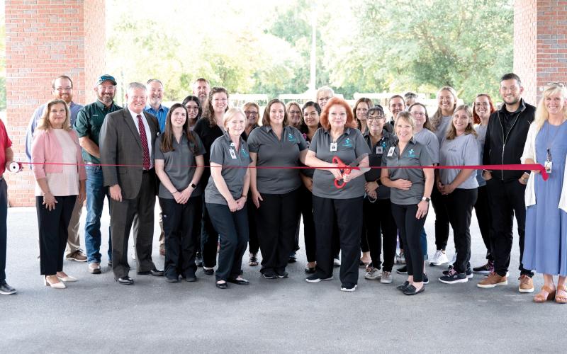 ACV Health cuts the ribbon to launch its rebrand Aug. 25 at Advent Christian VIllage’s Copeland Medical Center along with Suwannee County Chamber of Commerce and county officials. (COURTESY)