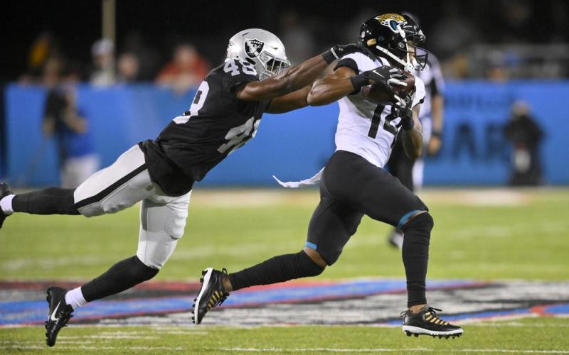 Jacksonville Jaguars wide receiver Marvin Hall runs after a catch with Las Vegas Raiders cornerback Sam Webb (48) defending during the Hall of Fame game on Thursday in Canton, Ohio. (DAVID RICHARD/Associated Press)