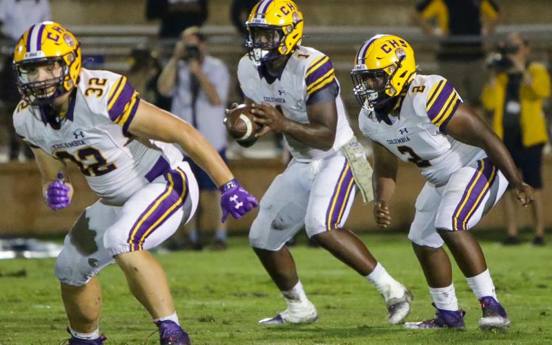 Columbia quarterback Tyler Jefferson (1) takes the snap alongside running back Tony Fulton (2) while fullback Colton Williams (32) heads up the field to block. (BRENT KUYKENDALL/Lake City Reporter)