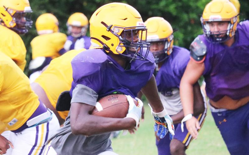 Columbia's Jaylen Cooper takes a handoff up the field during Monday's practice. (JORDAN KROEGER/Lake City Reporter)