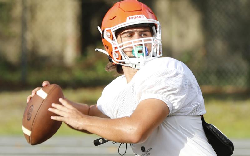 Branford quarterback Cohen David drops back to throw a pass during Friday’s practice. (JAMIE WACHTER/Lake City Reporter)