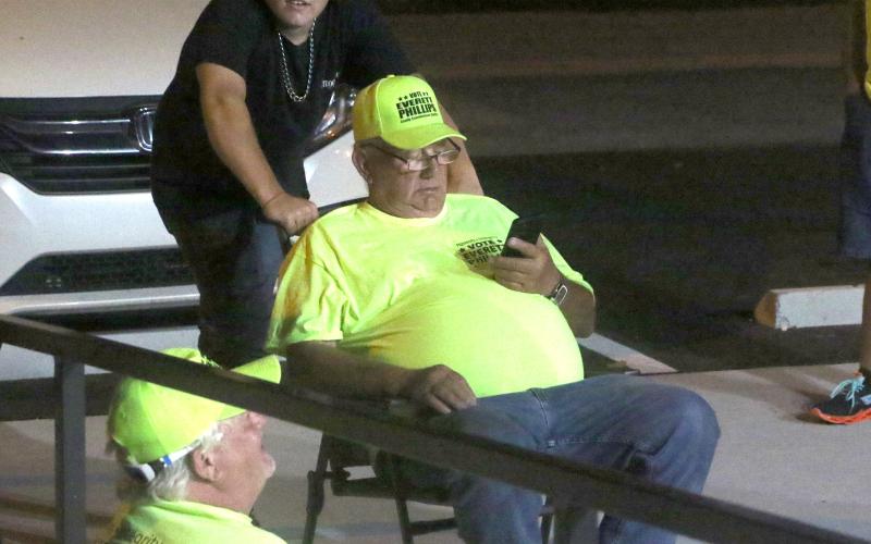 Everett Phillips watches the votes come in on his phone as he was elected to the County Commission. (MORGAN MCMULLEN/Lake City Reporter)