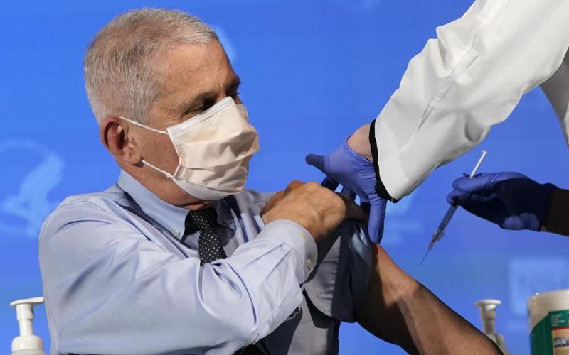 Dr. Anthony Fauci, director of the National Institute of Allergy and Infectious Diseases, prepares to receive his first dose of the covid-19 vaccine at the National Institutes of Health, Dec. 22, 2020, in Bethesda, Md. (PATRICK SEMANSKY/AP File)