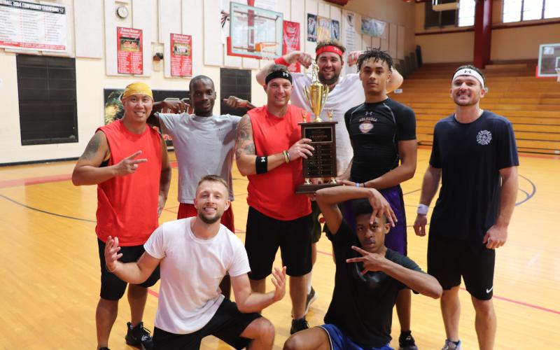 The Lake City Fire Department team poses with the newly won Boots and Badges Charity Basketball trophy. (COURTESY)