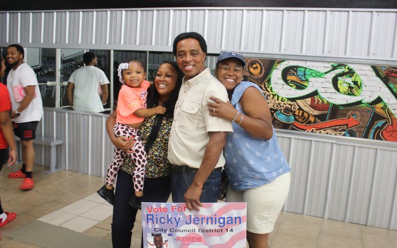 Ricky Jernigan (middle) stands with family members Ryleigh Jernigan (from left) as she’s held by Tiara Jernigan-Arline and Elena Jernigan-Highland during an election celebration party at Future Fitness on Tuesday night. (TONY BRITT/Lake City Reporter)