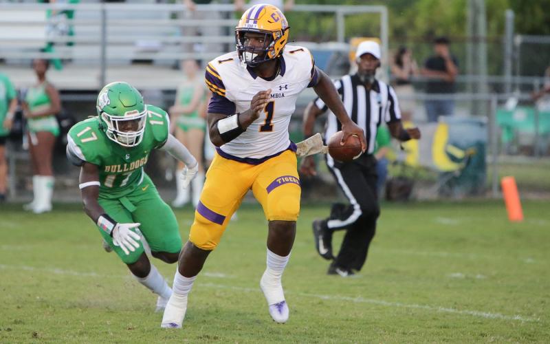 Columbia quarterback Tyler Jefferson is chased by Suwannee linebacker Delwyn Allen during Friday’s Preseason Classic. (BRENT KUYKENDALL/Lake City Reporter)