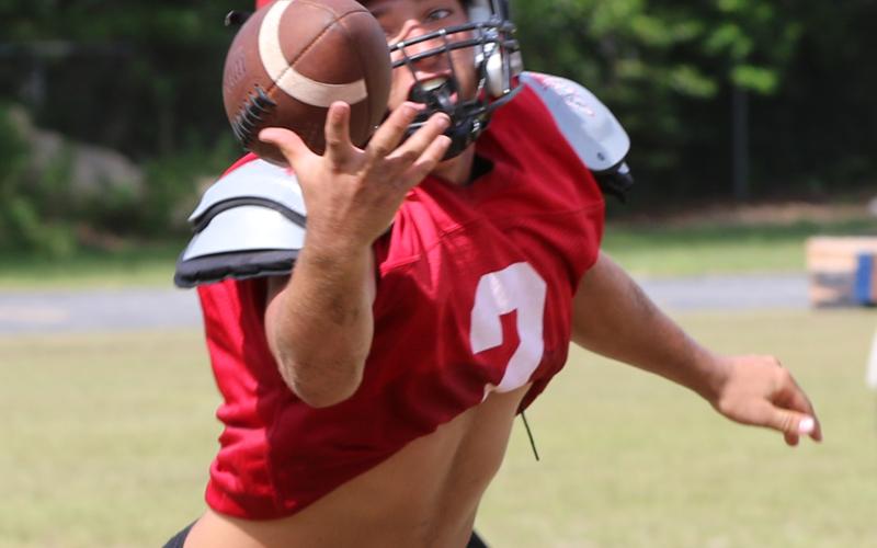 Lafayette’s Carter Higginbothom tries to reel in a catch during practice on Aug. 3. He’s one of two captains for the Hornets this season. (JAMIE WACHTER/Lake City Reporter)