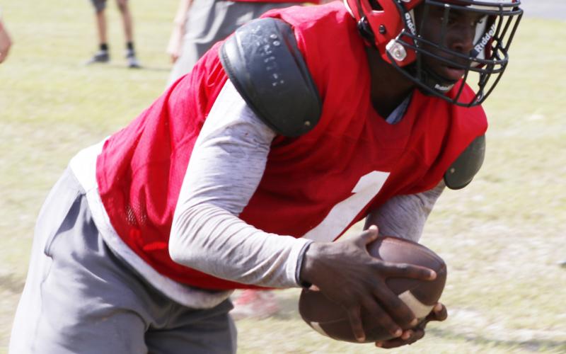 Lafayette’s Karlos Murphy scoops up a fumble during practice on Aug. 3. (JAMIE WACHTER/Lake City Reporter)