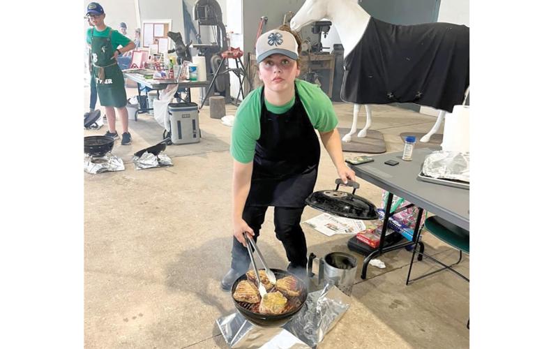 Lafayette 4-H’s AJ Swinson advanced to the state 4-H Tailgate and Grilling Competition after grilling pork chops at the district competition in July. (COURTESY)