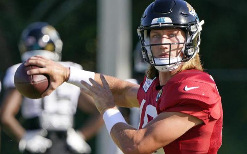 Jacksonville Jaguars quarterback Trevor Lawrence looks for a receiver during practice on July 31 in Jacksonville. (JOHN RAOUX/Associated Press)
