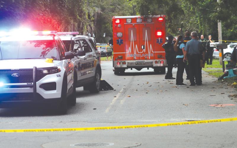 First responders arrived at the scene of a shooting incident around 5:05 p.m. Friday near Melrose Park Elementary School, cordoning off the intersection of SE Putnam Street and SE Baker Avenue. (TONY BRITT/Lake City Reporter)