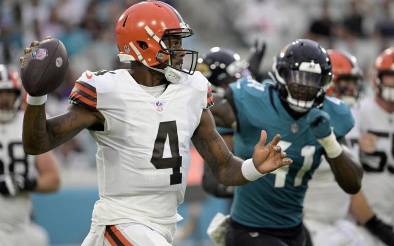 Cleveland Browns quarterback Deshaun Watson looks for a receiver as he is pressured by Jacksonville Jaguars linebacker Josh Allen during Friday’s preseason game in Jacksonville. (PHELAN M. EBENHACK/Associated Press)