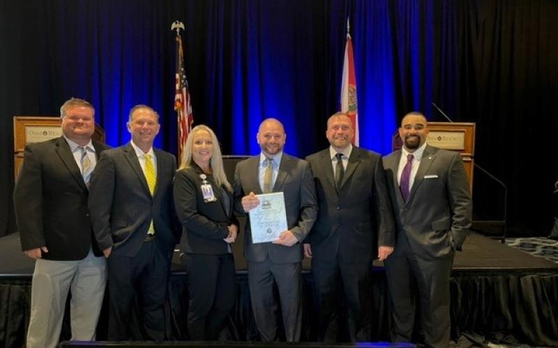 Dr. Colby Redfield, Century Ambulance’s Medical Director (center), was honored with the Raymond H. Alexander - EMS Medical Direction Award from the Florida Department of Health. Joining Dr. Redfield at the EMS Provider Awards on Wednesday were Brent Allen (from left), Matt Johnson, Karen Robeson, Aaron Smith and Alex Igartua. (COURTESY)