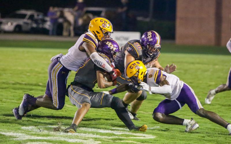 Columbia High linebacker Tyrell Peterson (left) and defensive back Jaylen Cooper converge on a Union County ballcarrier last week. The Tigers are looking to pick up their first win of the season when Deland visits Tiger Stadium tonight. (BRENT KUYKENDALL/Lake City Reporter)