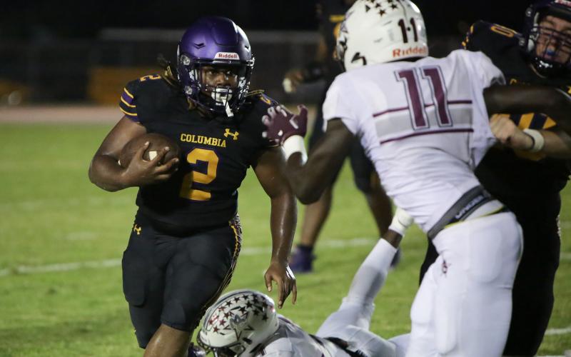 Columbia running back Tony Fulton carries the ball up the field against Madison County on Friday. (BRENT KUYKENDALL/Lake City Reporter)