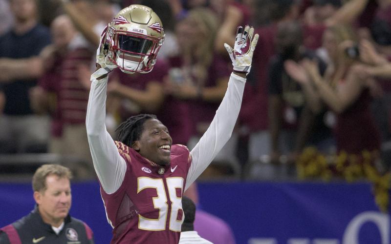 Florida State defensive back Shyheim Brown (38) celebrates a dropped punt catch by LSU and recovery by Florida State in the second half of Sunday’s game in New Orleans. Brown would later seal Florida State’s 24-23 victory by blocking an extra point kick attempt by LSU. (MATTHEW HINTON/Associated Press)