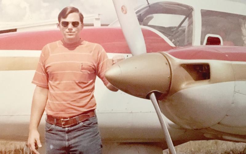 Billy Dekle stands with a Piper Aztec plane in the late 1970s when he began flying trips to Central and South America to bring marijuana to Florida as part of a smuggling operation, which he has written about in ‘Flying High with Gringo Billy.’ (COURTESY)