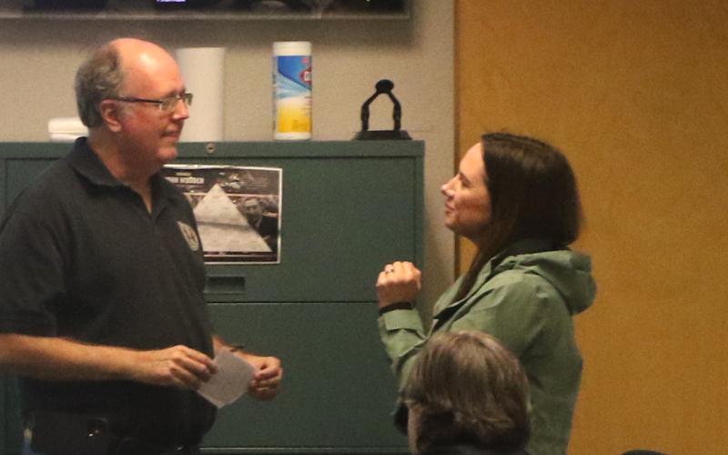 Emergency Management Director Shayne Morgan (left) and county spokeswoman Paula Vann converse Wednesday at the county’s Combined Communications Center. (MORGAN MCMULLEN/Lake City Reporter)