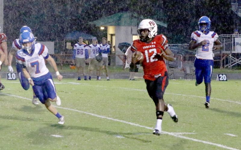 Fort White’s Najeeb Smith throws up a peace sign on his first rushing touchdown Friday night against Keystone Heights. (MORGAN MCMULLEN/Lake City Reporter)