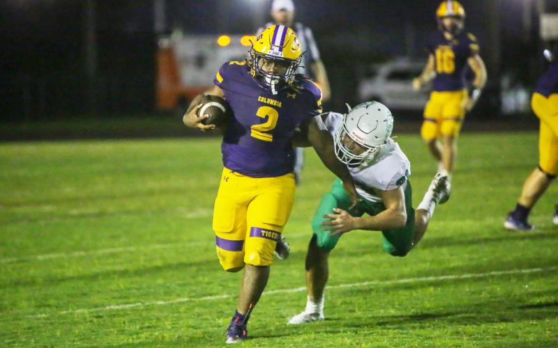 Columbia running back Tony Fulton races past a DeLand defender on Friday. (BRENT KUYKENDALL/Lake City Reporter)