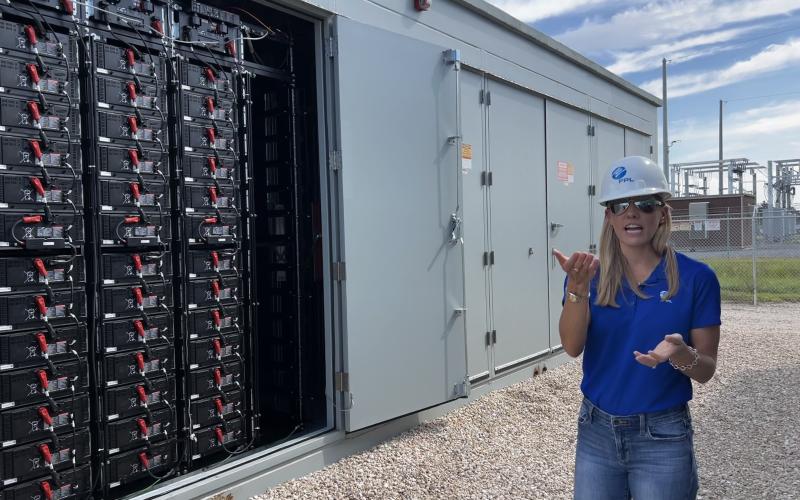 Stevany Cole, a project developer with Florida Power &amp; Light, speaks about the battery storage technology utilized at the Echo River Solar Energy Center in Suwannee County on Thursday. (JAMIE WACHTER/Lake City Reporter)