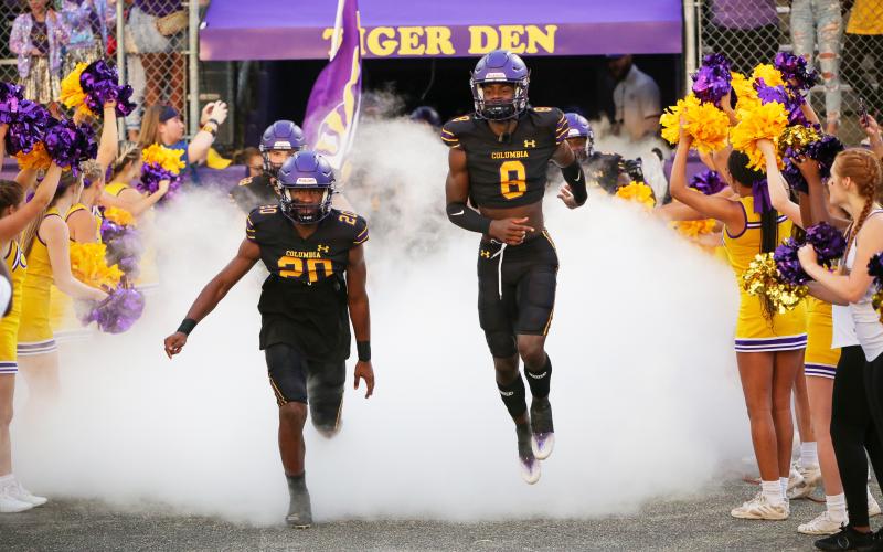 Columbia cornerback Kani Fulton (20) and cornerback/receiver Jaylen Cooper (8) lead their team out of the tunnel prior to last Friday’s game against Madison County. (BRENT KUYKENDALL/Lake City Reporter)