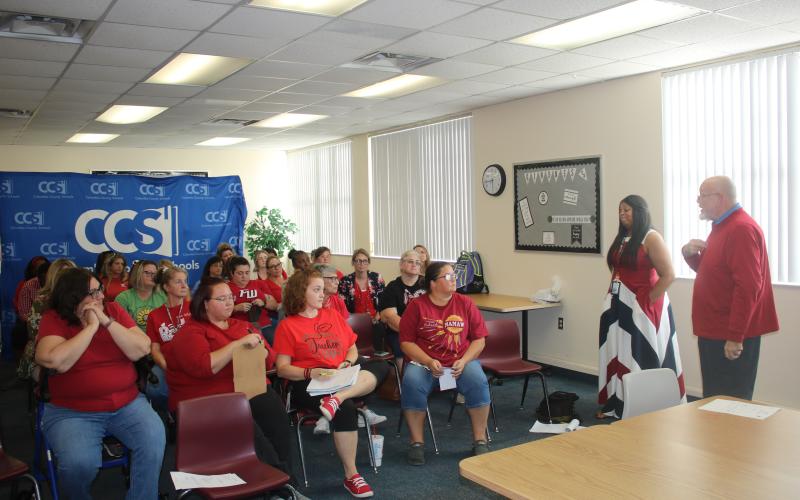 Mickey Garrett (right), a Pathways Academy instructor and Columbia Teachers Association negotiator, speaks to a group of educators Thursday afternoon. (TONY BRITT/Lake City Reporter)
