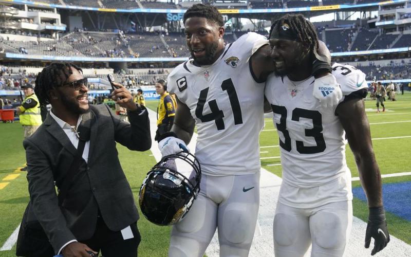 Jacksonville Jaguars linebacker Josh Allen (41) and linebacker Devin Lloyd (33) walk off the field after Sunday's win over the Los Angeles Chargers in Inglewood, Calif. (MARCIO JOSE SANCHEZ/Associated Press)