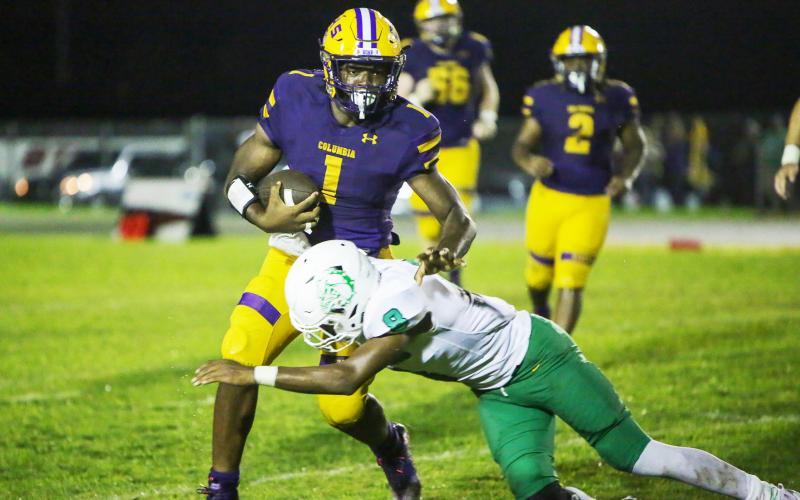 Columbia quarterback Tyler Jefferson is tackled by a DeLand defender during Friday’s game. (BRENT KUYKENDALL/Lake City Reporter)