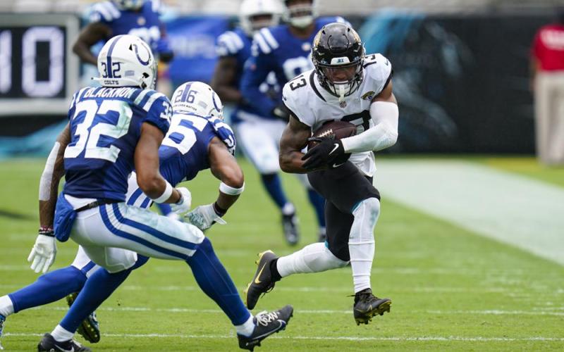 Jacksonville Jaguars wide receiver Christian Kirk (13) tries to get past Indianapolis Colts safeties Julian Blackmon (32) and Rodney McLeod (26) during Sunday's game in Jacksonville. (JOHN RAOUX/Associated Press)