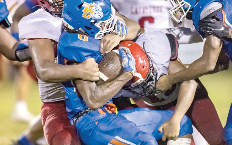A pair of Lafayette High defenders wrap up a Taylor County ballcarrier last week. (JACK HOWDESHELL/Special to the Reporter)