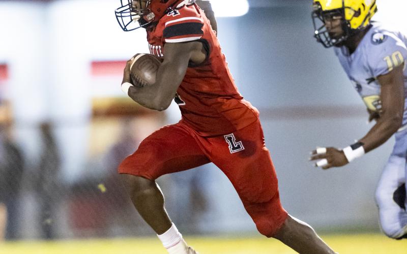 Lafayette running back Kiami McKnight pulls away from a Zarephath Academy defender on a touchdown run Friday night at Dale Walker Field. (JACK HOWDESHELL/Special to the Reporter)