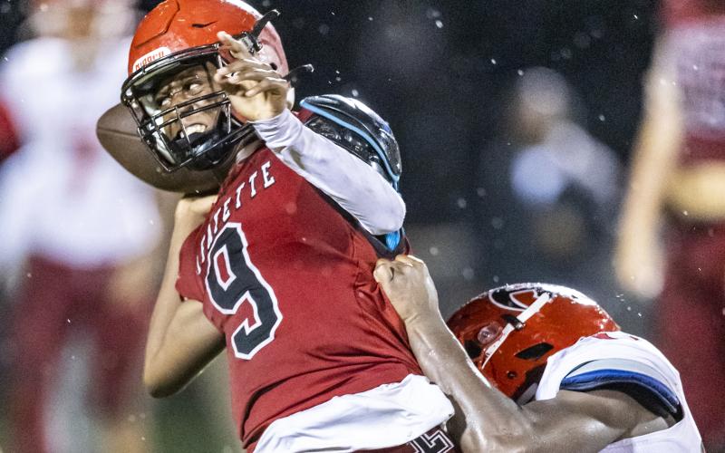 Lafayette quarterback Tywan Williamson avoids a sack by throwing the ball away against Hamilton County on Friday. (JACK HOWDESHELL/Special to the Reporter)