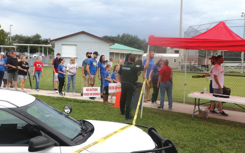 Visitors at last Friday’s Fort White-Newberry football game are searched for weapons and any other hazardous materials on their way into Arrowhead Stadium at Fort White High School. (MORGAN MCMULLEN/Lake City Reporter)