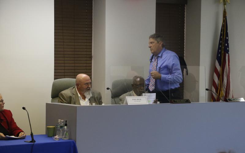 Councilman Todd Sampson leaves the dais as City Manager Paul Dyal speaks near the end of the Lake City Council meeting Tuesday. Sampson would return to his seat to respond to Dyal. (MORGAN MCMULLEN/Lake City Reporter)
