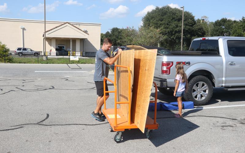 Bryce Lay loads up plywood at Home Depot on Monday as he makes preparations for Hurricane Ian. (MORGAN MCMULLEN/Lake City Reporter)