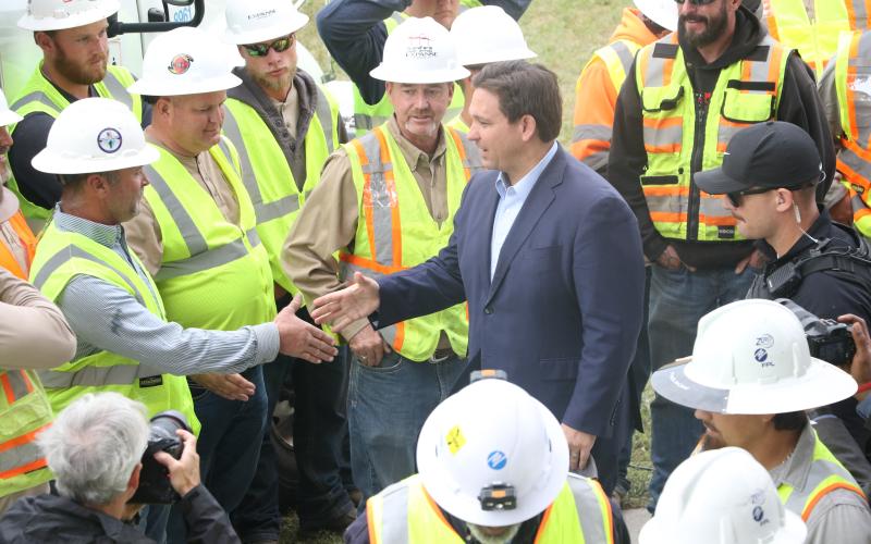 Gov. Ron DeSantis shakes hands with linemen at the Florida Power &amp; Light processing site at the Florida Gateway Fairgrounds on Wednesday morning following a press conference to address Hurricane Ian. (MORGAN MCMULLEN/Lake City Reporter)